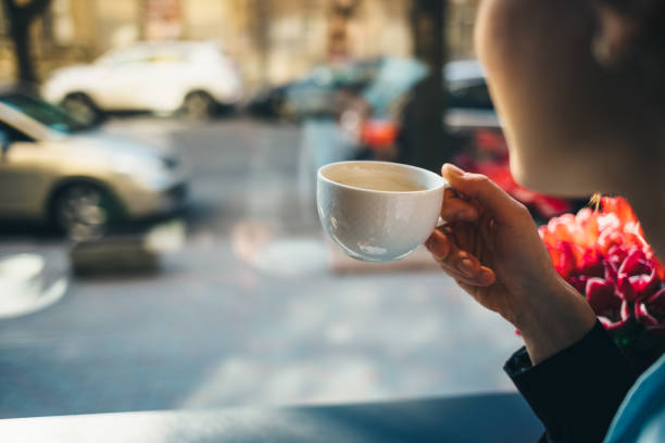 istock Woman drinking coffee in cafe 1148418473