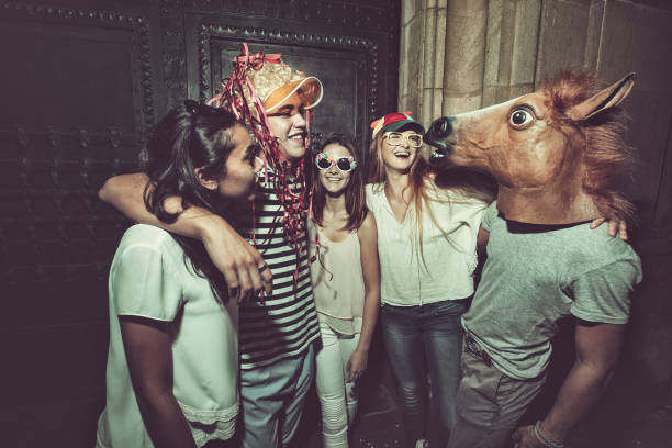 Megaparty: friends party wild in the streets Megaparty: friends party wild in the streets, with fireworks and confetti mask disguise stock pictures, royalty-free photos & images