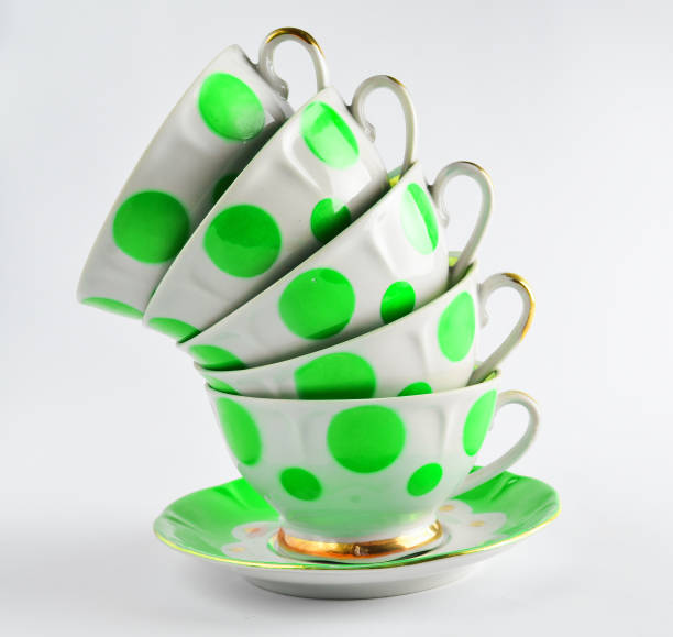istock A stack of antique ceramic cups on a saucer on a white background 1148421539