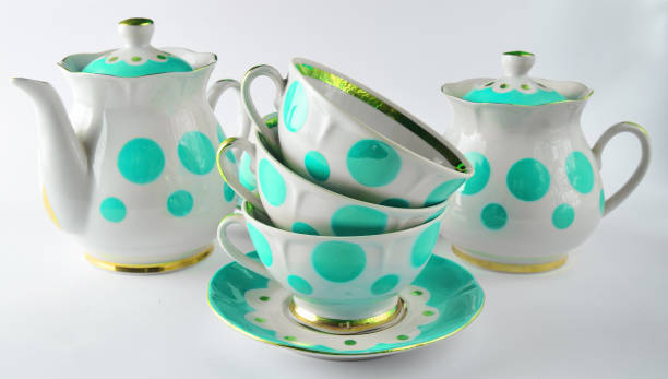 istock Stack of antique ceramic cups on a saucer, teapots, sugar bowls on a white background 1148422059