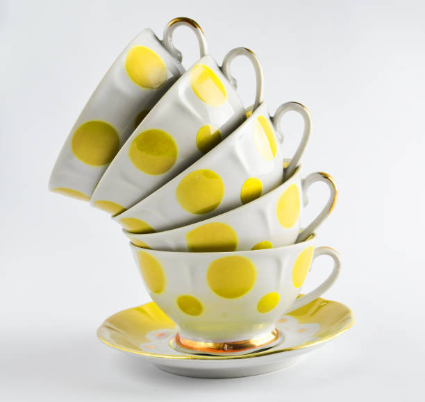 istock A stack of antique ceramic cups on a saucer on a white background 1148422107
