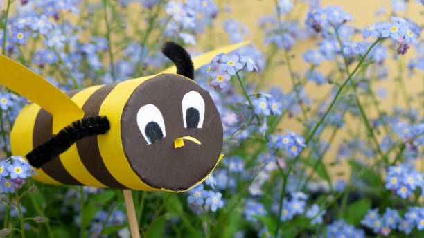 istock paper bee flying in the garden 1148422604