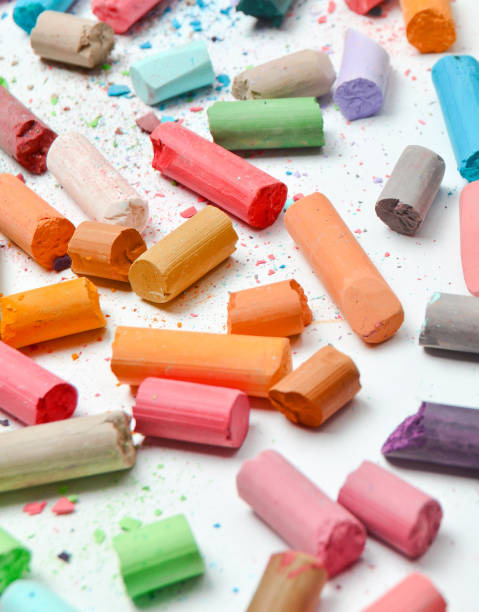 istock Many multicolored pastel crayons on a white background. 1148422884