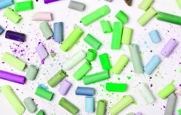 istock Background of many multicolored pastel crayons on a white background, top view 1148422888