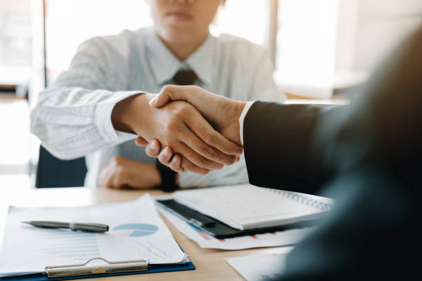istock Businessman shaking hands with customer in office. 1148423768
