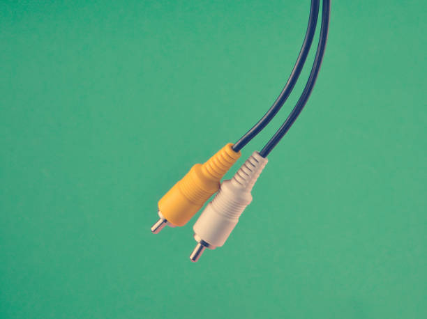 istock RCA yellow white audio/video cable on blue background. 1148424135