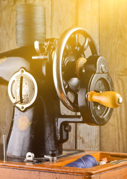 istock Classic retro style manual sewing machine on a wooden background 1148424298