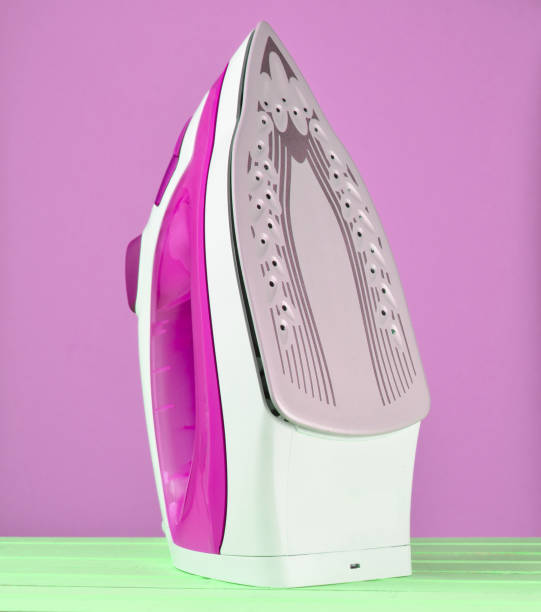 istock Iron for ironing on a colored pastel background, minimalist trend 1148425399