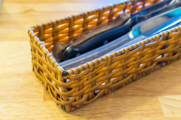 Wicker basket for cutlery on wooden table in cafe
