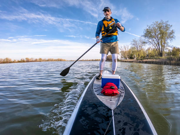 Stand up paddling on a calm lake.