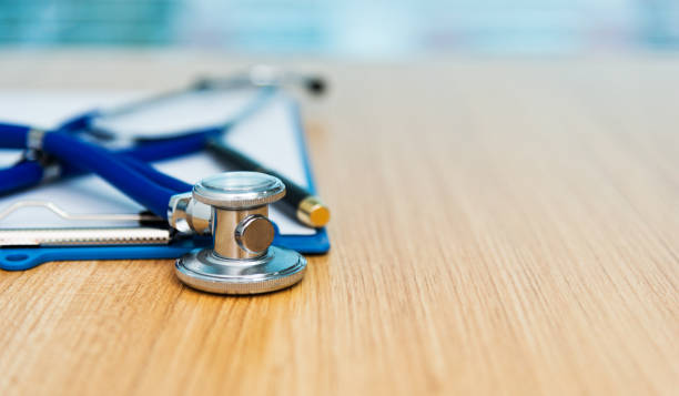 istock Clipboard with stethoscope and pen on desk 1148426625