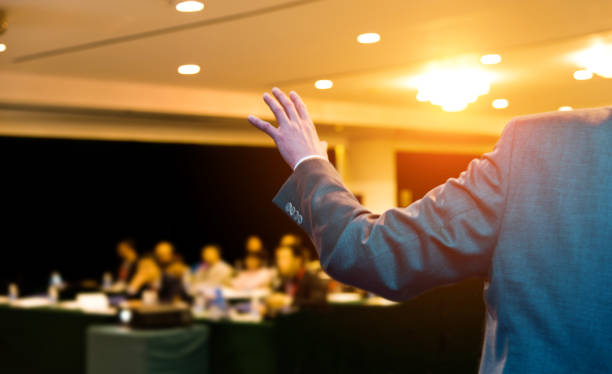 istock Unrecognizable businessman making a speech in front of audience at conference hall 1148429445