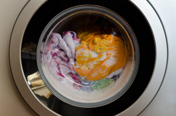 istock Washing machine door with rotating garments inside 1148429493