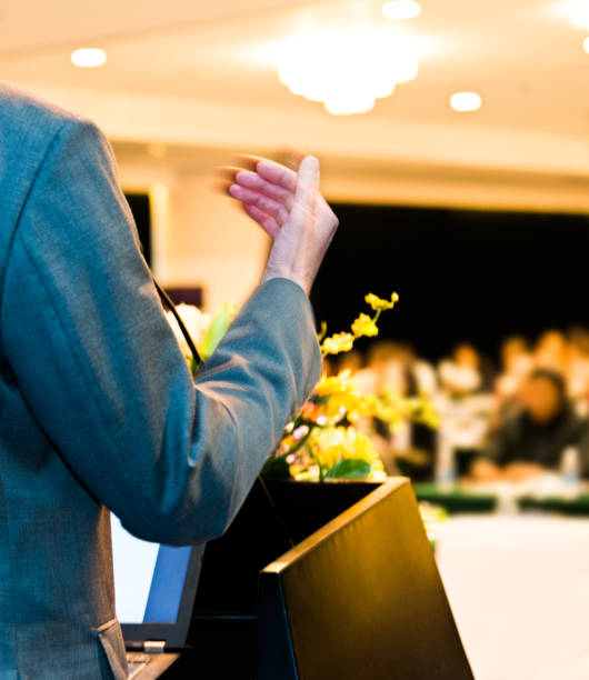 istock Unrecognizable businessman making a speech in front of audience at conference hall 1148429621
