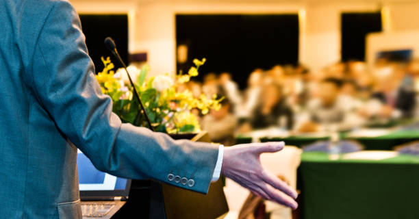 istock Unrecognizable businessman making a speech in front of audience at conference hall 1148429985