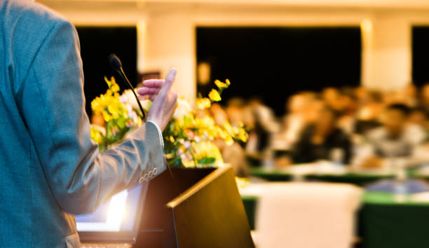 istock Unrecognizable businessman making a speech in front of audience at conference hall 1148430137
