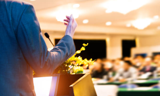 istock Unrecognizable businessman making a speech in front of audience at conference hall 1148430224
