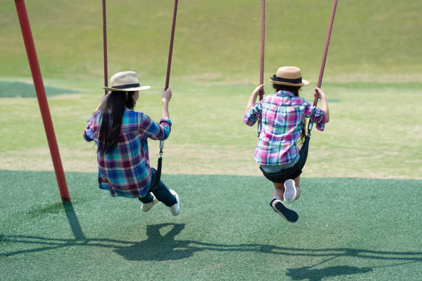 istock Mother and daughter playing in the park 1148431052