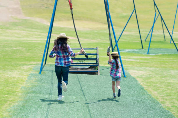 istock Mother and daughter playing in the park 1148431096