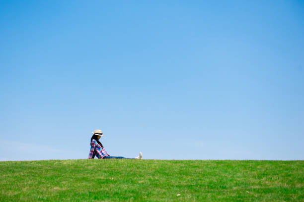 istock Beautiful woman relaxing in the meadow 1148431214