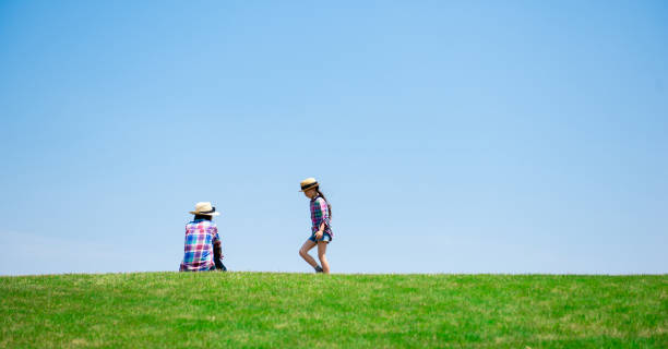 istock Mother and daughter playing in the meadow 1148431440