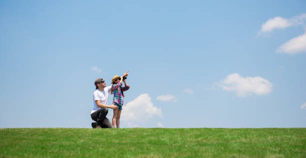 istock Father and daughter looking afar with binoculars 1148431453