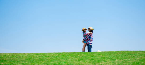 istock Mother and daughter playing in the meadow 1148431509