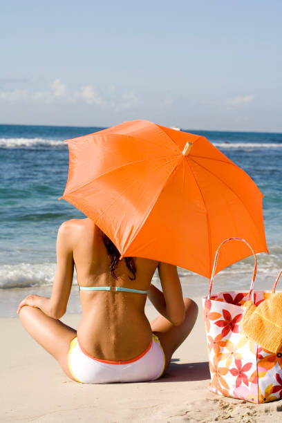 istock woman in swimsuit on the beach 1148432290