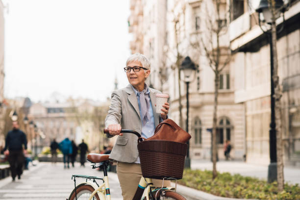 istock Woman riding bicycle and drinking coffee 1148432827
