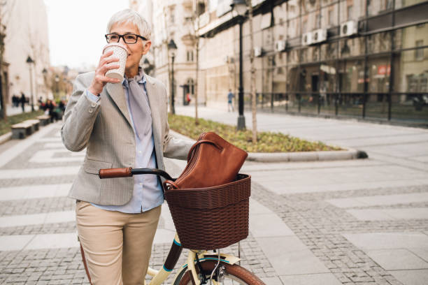 istock Woman drinking coffee when riding bicycle 1148432832