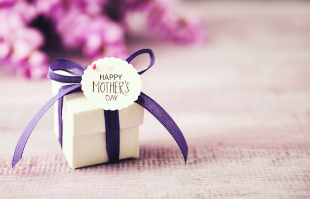 Mother's Day gift box with purple ribbon and wisteria bouquet