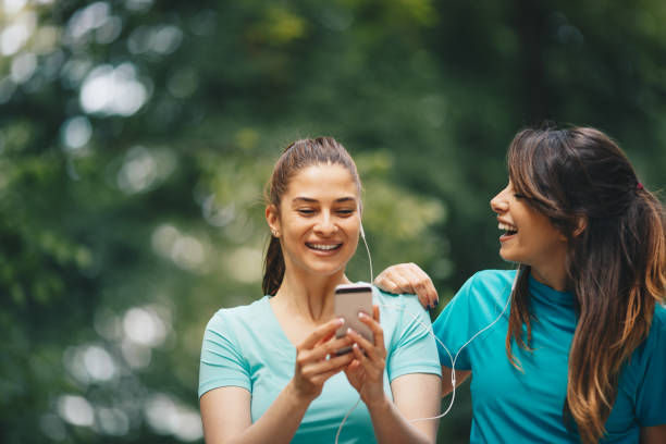 istock Two women taking a break and using her smartphone 1148439219