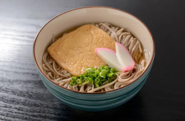 Soba. Buckwheat noodles.Japanese food.
 Soba noodles in a hot soup with deep-fried tofu