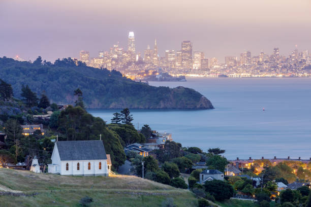 Scenic views of Old St Hillary's Church, Angel Island, Alcatraz Prison, San Francisco Bay and San Francisco Skyline at dusk. Shot from Tiburon, Marin County, California, USA. marin county stock pictures, royalty-free photos & images