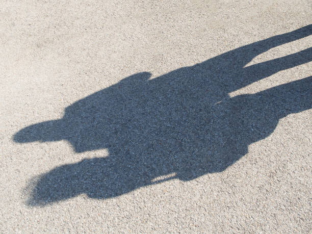 istock Shadows of people on a concrete pavement 1148441340