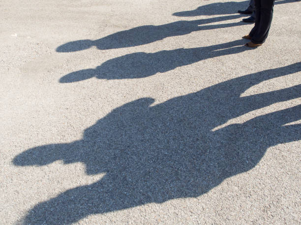 istock Shadows of people on a concrete pavement 1148441342