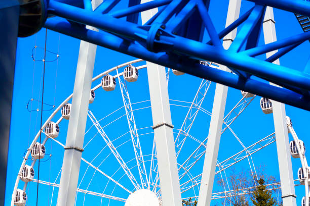 karuzela atrakcją jeździć biały diabelski młyn w parku rozrywki przed błękitnym niebem - carnival spinning built structure frame zdjęcia i obrazy z banku zdjęć