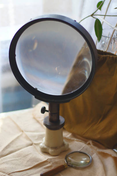 istock Big and small vintage old optical magnifying glasses lenses on canvas fabric. Science  search concept 1148446787