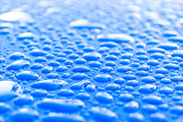istock Transparent still water drops on light blue background. Blue water drops. Drops of rain on glass. Blue abstract water drop background. Water surface 1148447372