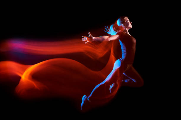 istock Sport woman running, with a light train behind her 1148448493