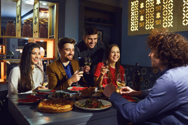 istock Friends talk fun at the table in the restaurant 1148450469
