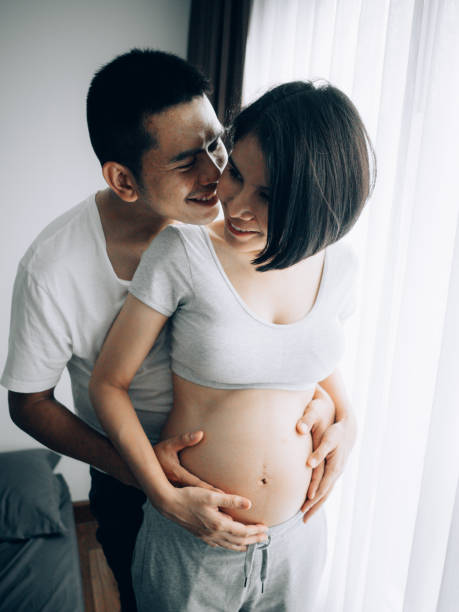 istock Affectionate pregnant couple hugging at home. 1148450508