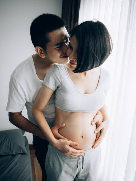 istock Lovely couple. Enjoying home preparing for baby 1148450509