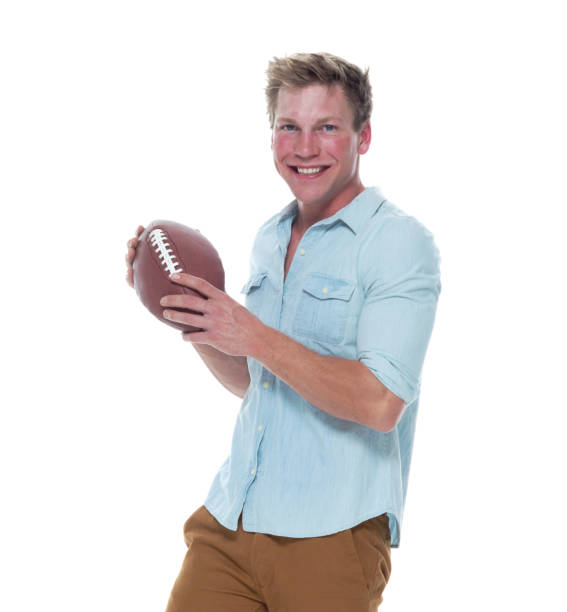 istock Casually dressed man holding a football 1148452316