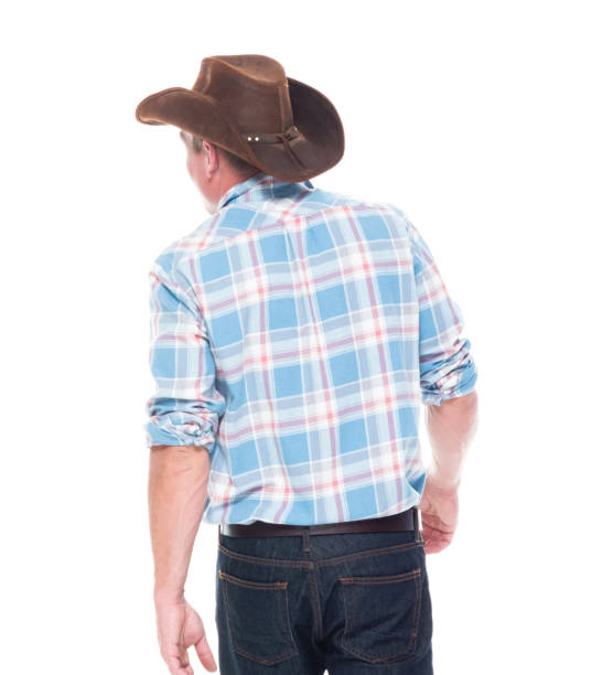 istock Handsome cowboy is walking, rear view 1148452620