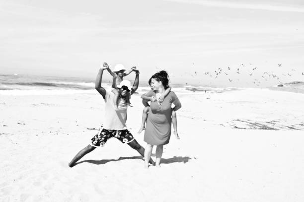 istock Young family (with kids) on a beachside. Black and white 1148455442