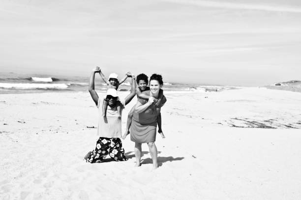 istock Young family (with kids) on a beachside. Black and white 1148456424