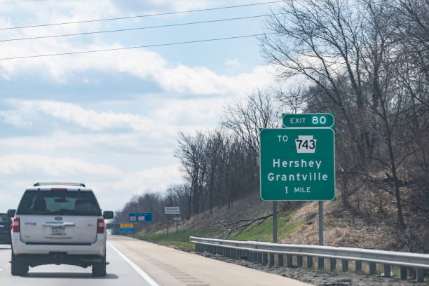 road sign to hershey and grantville cities in pennsylvania on interstate highway 81 - hersheys imagens e fotografias de stock