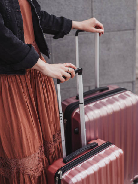 istock Woman with luggage suitcases 1148457947