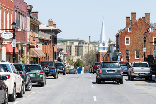 Historic downtown at main street in Lexington, Virginia with shops, stores, First Baptist church Lexington, USA - April 18, 2018: Historic downtown town city in Virginia countryside Shenandoah mountain village, signs for shops and stores, First Baptist church on main street restaurant labor union stock pictures, royalty-free photos & images